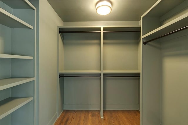 walk in closet with hardwood / wood-style floors