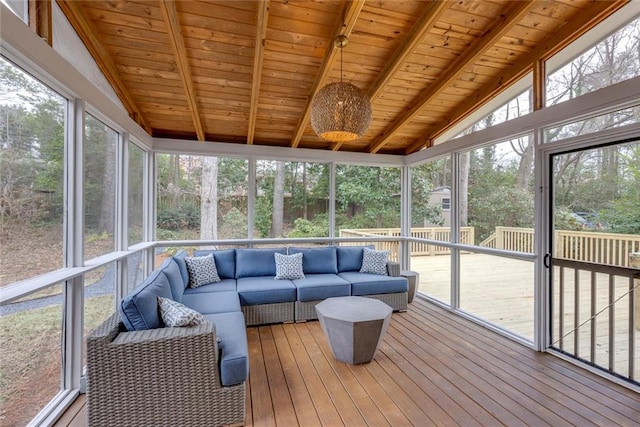 sunroom / solarium featuring lofted ceiling with beams, a wealth of natural light, and wooden ceiling