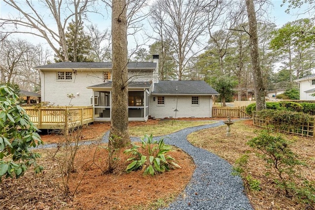 back of house with a wooden deck