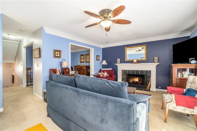 carpeted living room with ceiling fan, ornamental molding, and a fireplace