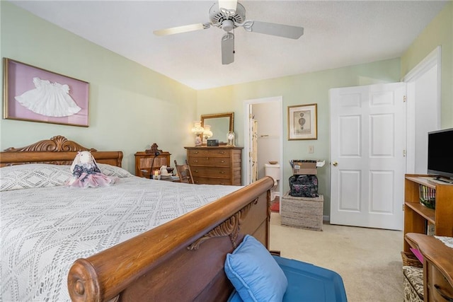 bedroom with light carpet, ensuite bath, and ceiling fan