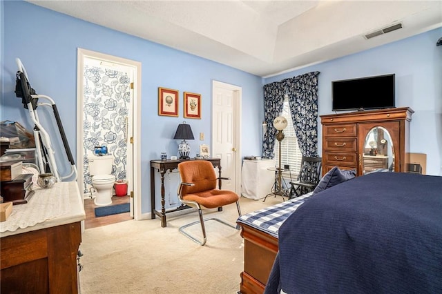 carpeted bedroom featuring connected bathroom