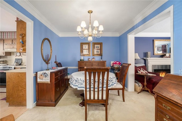 carpeted dining room featuring an inviting chandelier, crown molding, and a tiled fireplace