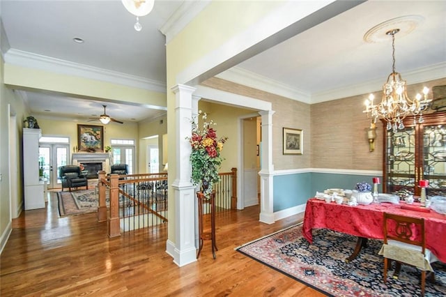 1173 Saint Charles Pl, Gainesville, GA 30501 - dining area with wainscoting, wood finished floors, ceiling fan, ornamental molding, and a glass covered fireplace