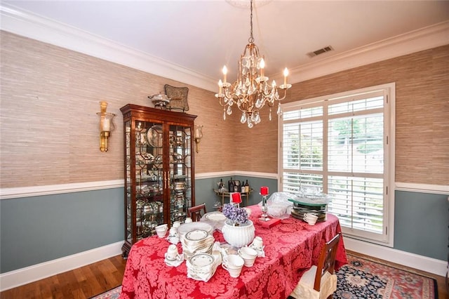 1173 Saint Charles Pl, Gainesville, GA 30501 - dining space featuring wallpapered walls, a chandelier, wood finished floors, a wainscoted wall, and crown molding