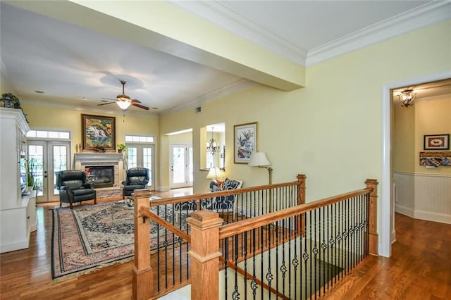 1173 Saint Charles Pl, Gainesville, GA 30501 - hall with an upstairs landing, wood finished floors, ornamental molding, a wainscoted wall, and a chandelier