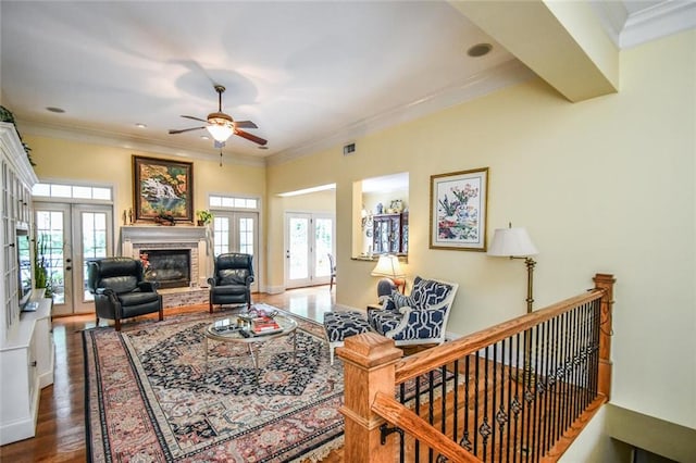 1173 Saint Charles Pl, Gainesville, GA 30501 - living area with french doors, a ceiling fan, a brick fireplace, crown molding, and wood finished floors