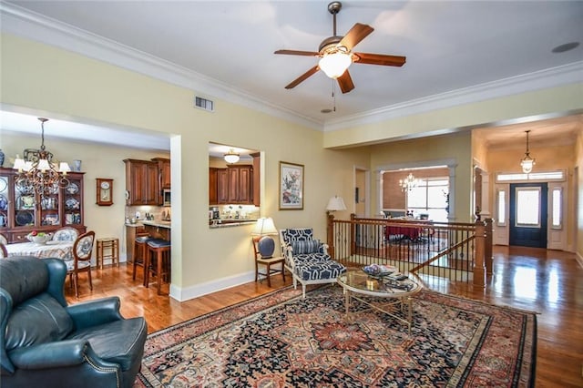 1173 Saint Charles Pl, Gainesville, GA 30501 - living room featuring a chandelier, crown molding, wood finished floors, and ceiling fan