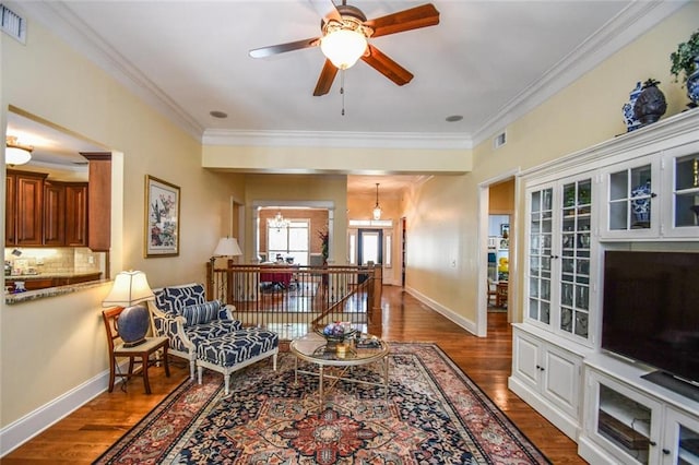 1173 Saint Charles Pl, Gainesville, GA 30501 - living room featuring wood finished floors, crown molding, a ceiling fan, and a chandelier