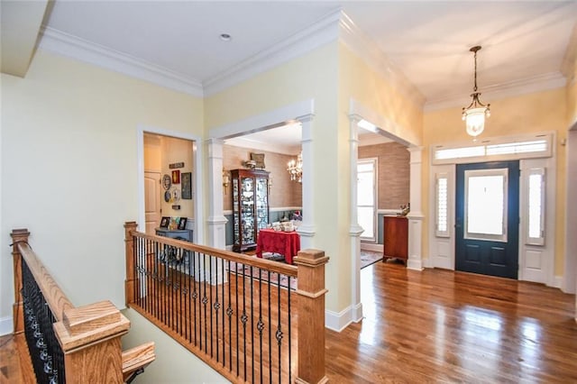 1173 Saint Charles Pl, Gainesville, GA 30501 - entrance foyer featuring ornate columns, ornamental molding, wood finished floors, and a chandelier
