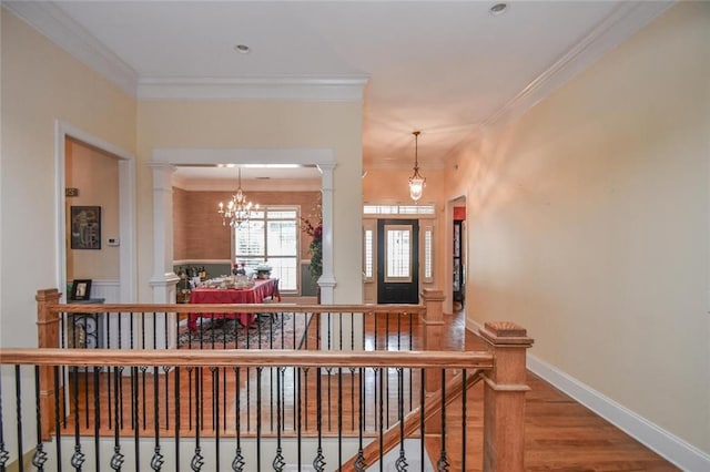 1173 Saint Charles Pl, Gainesville, GA 30501 - foyer with ornate columns, ornamental molding, wood finished floors, and a chandelier