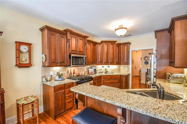 1173 Saint Charles Pl, Gainesville, GA 30501 - kitchen with stainless steel microwave, a peninsula, light stone countertops, ornamental molding, and decorative backsplash
