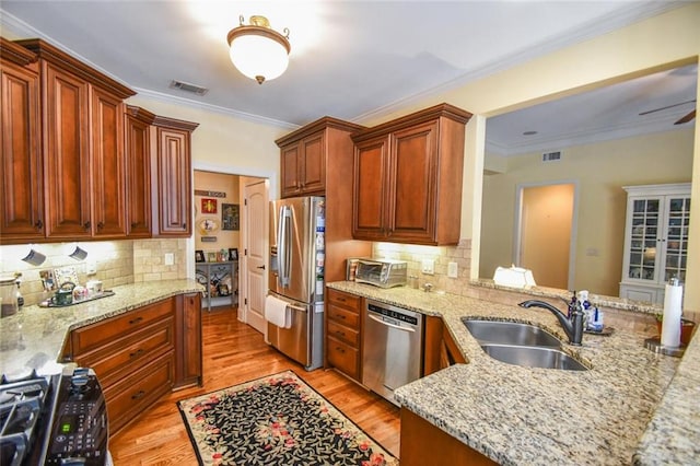 1173 Saint Charles Pl, Gainesville, GA 30501 - kitchen featuring stainless steel appliances, backsplash, light wood-style flooring, light stone countertops, and crown molding