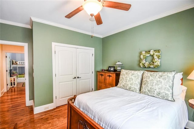 1173 Saint Charles Pl, Gainesville, GA 30501 - bedroom featuring ornamental molding, wood finished floors, a closet, and ceiling fan