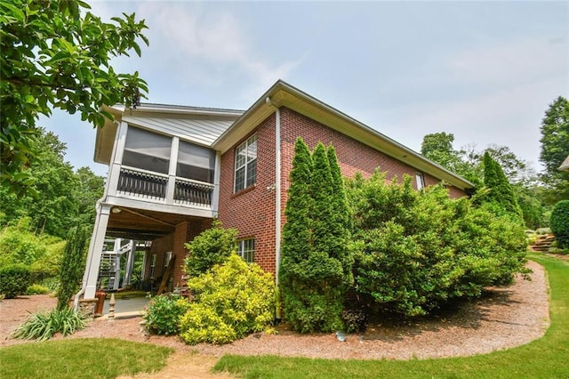 1173 Saint Charles Pl, Gainesville, GA 30501 - view of property exterior featuring brick siding, a sunroom, and a patio area