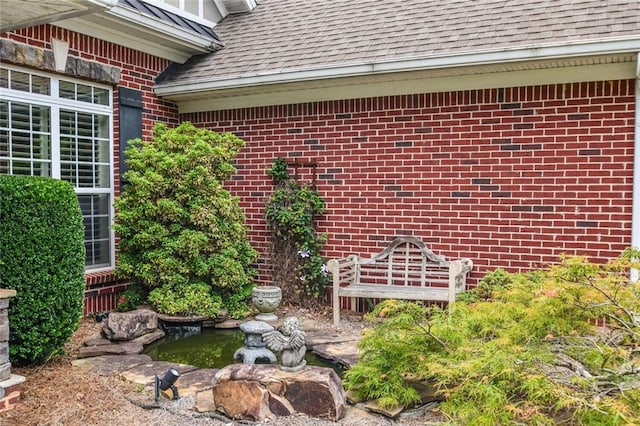 1173 Saint Charles Pl, Gainesville, GA 30501 - doorway to property with a small pond, roof with shingles, and brick siding