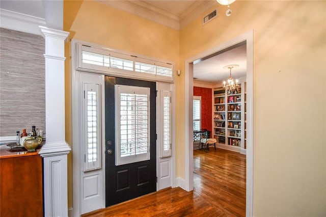1173 Saint Charles Pl, Gainesville, GA 30501 - entryway with wood finished floors, ornamental molding, and a chandelier