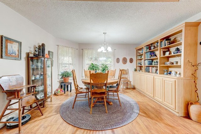 living room featuring a fireplace, light hardwood / wood-style floors, high vaulted ceiling, and ceiling fan