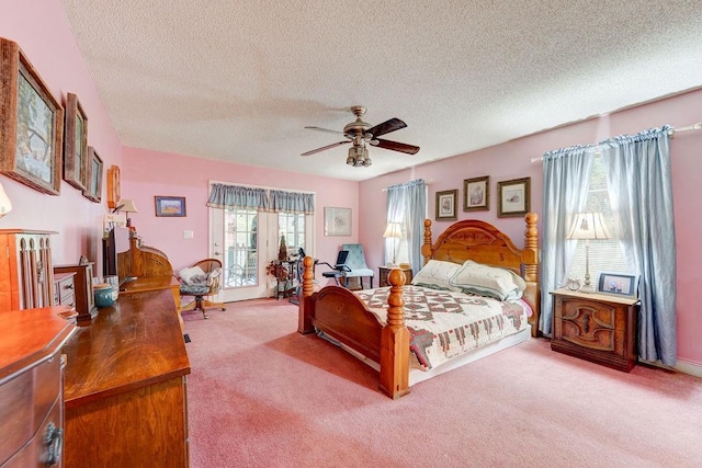 bedroom with ceiling fan, access to outside, carpet floors, and a textured ceiling