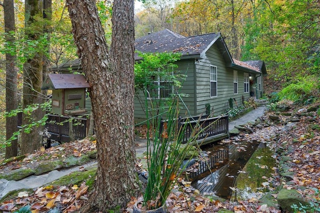 view of side of property featuring a wooden deck