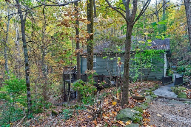 view of side of home with a wooden deck