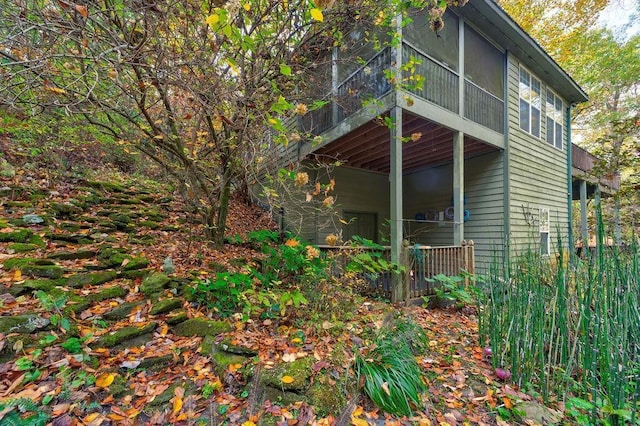 view of home's exterior with a sunroom