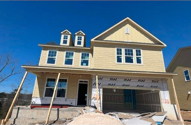 view of front facade with a porch, board and batten siding, and an attached garage