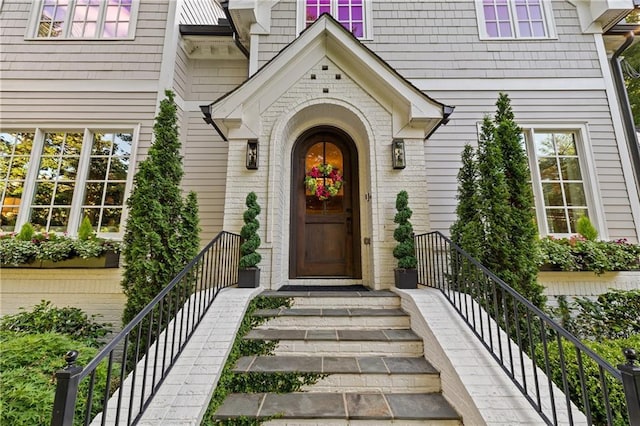 doorway to property with brick siding