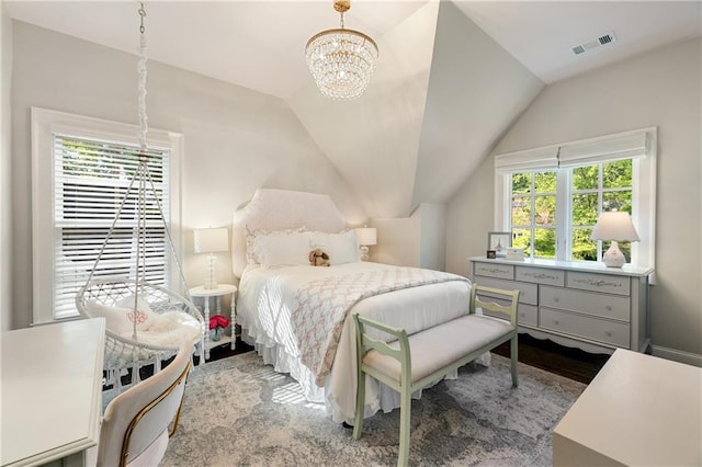 bedroom featuring a chandelier, lofted ceiling, and wood finished floors