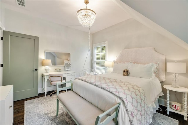 bedroom featuring wood finished floors, a chandelier, and baseboards
