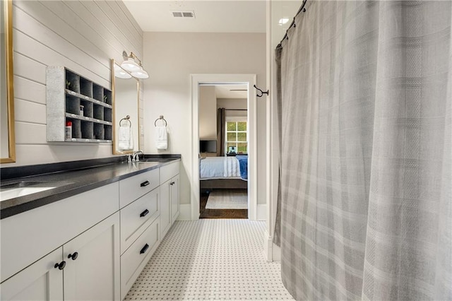 full bath with double vanity, tile patterned floors, and ensuite bath