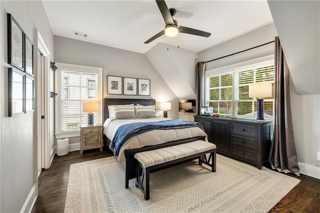 bedroom with multiple windows, baseboards, wood finished floors, and ceiling fan