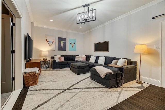 living room featuring ornamental molding, recessed lighting, wood finished floors, a chandelier, and baseboards