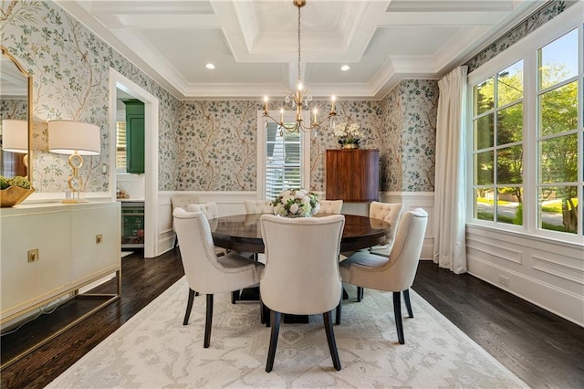 dining area with a chandelier, healthy amount of natural light, dark wood-style floors, wainscoting, and wallpapered walls
