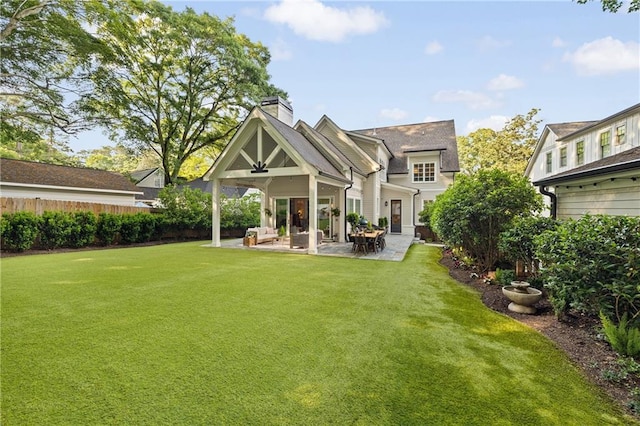 back of house with a chimney and a patio area