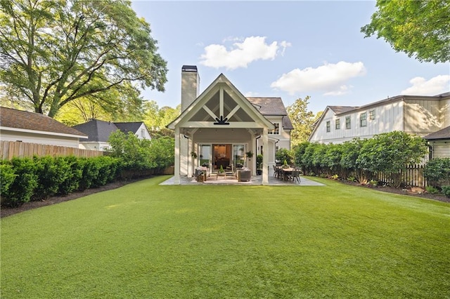 rear view of house with a patio and a chimney