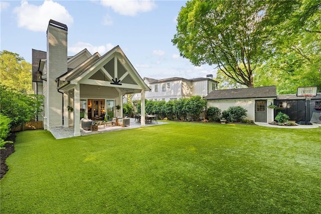 rear view of house with a chimney, a patio, and ceiling fan