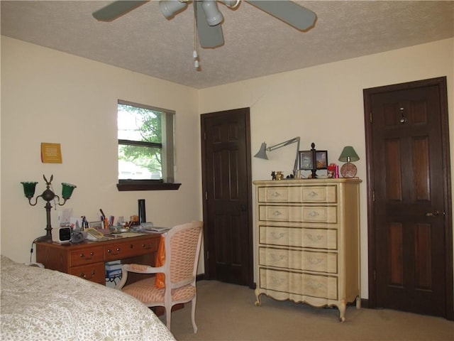 bedroom with light carpet, a textured ceiling, and a ceiling fan