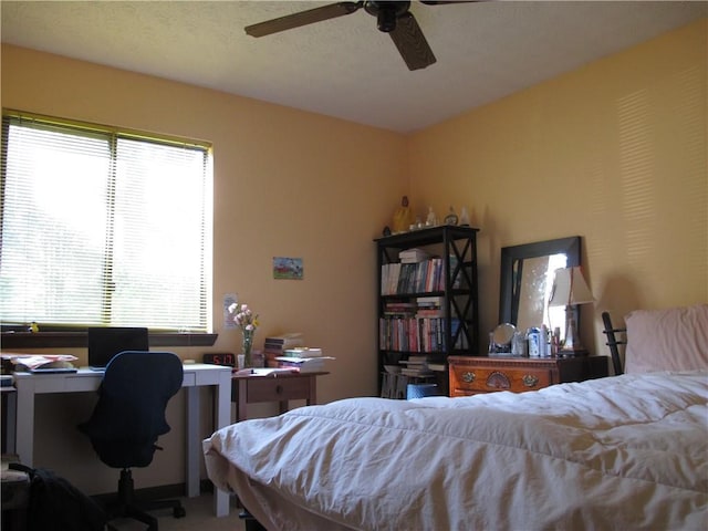 bedroom featuring a desk and ceiling fan