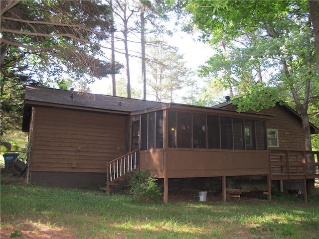 back of house with a sunroom and a deck