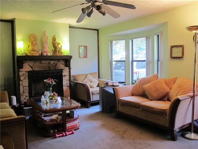 carpeted living room featuring a ceiling fan and a fireplace