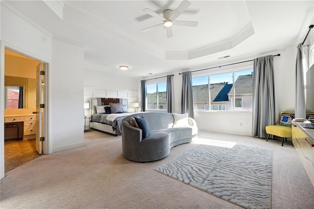 carpeted bedroom featuring ceiling fan, crown molding, and a tray ceiling