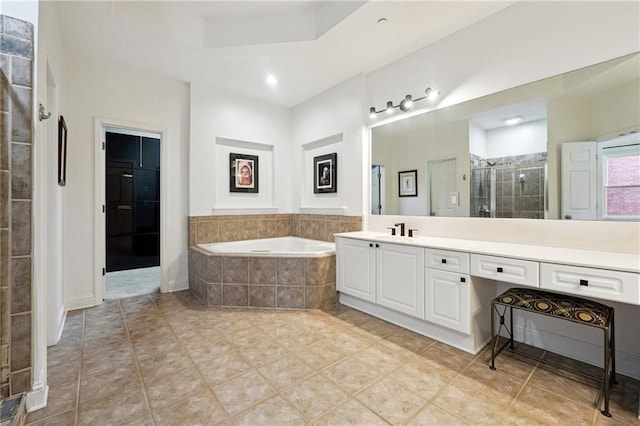 bathroom featuring tile patterned floors, vanity, and shower with separate bathtub