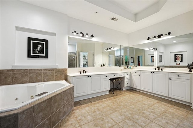 bathroom with plus walk in shower, tile patterned flooring, and vanity