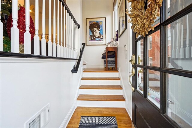 stairway featuring hardwood / wood-style floors and plenty of natural light