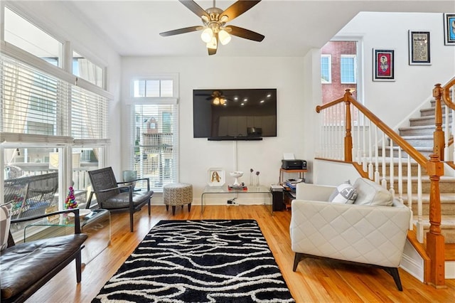 living room featuring hardwood / wood-style flooring, ceiling fan, and a healthy amount of sunlight