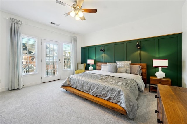 bedroom with access to exterior, ceiling fan, and light colored carpet