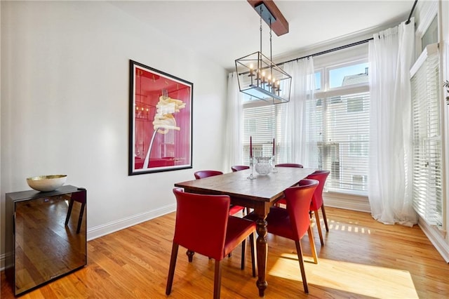 dining room featuring light hardwood / wood-style flooring and a notable chandelier