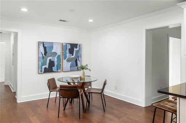 dining room featuring baseboards, dark wood-style flooring, and ornamental molding