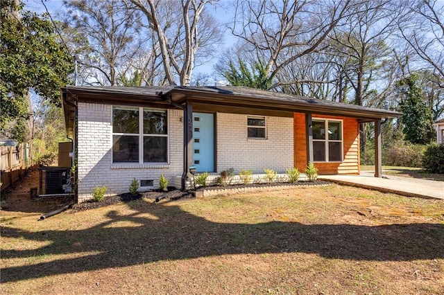 view of front facade featuring brick siding and fence